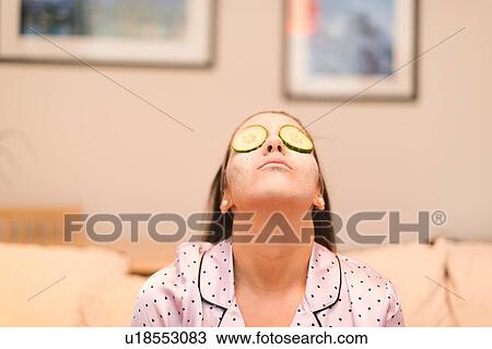 Stock Image - Young woman wearing face mask. Fotosearch