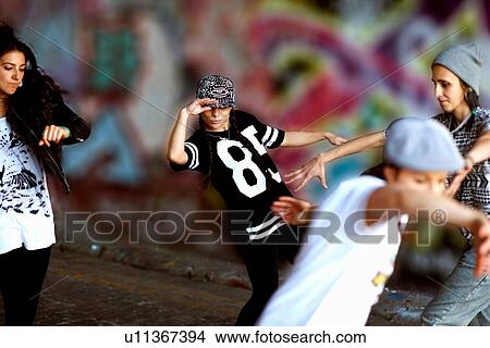 Young women breakdancing against street art View Large Photo Image Picture - Young women breakdancing against street art. Fotosearch