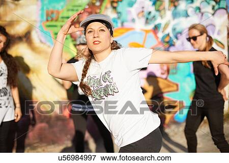 Young women breakdancing, arms raised, looking away View Large Photo Image Stock Photo - Young women breakdancing, arms raised, looking away. Fotosearch