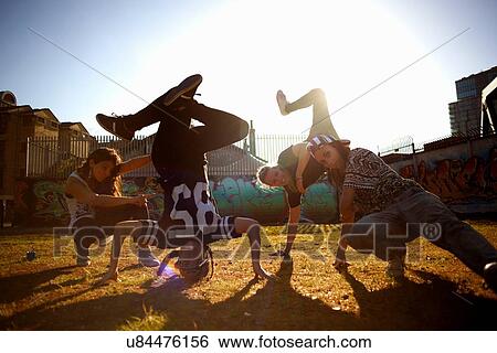 Stock Photograph - Young women breakdancing headstand freeze. Fotosearch