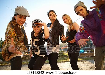 Young women standing gesturing to camera View Large Photo Image Stock Image - Young women standing gesturing to camera. Fotosearch