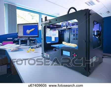 Stock Photography - 3D printing machine with CAD design on screen in orthopaedic factory. Fotosearch