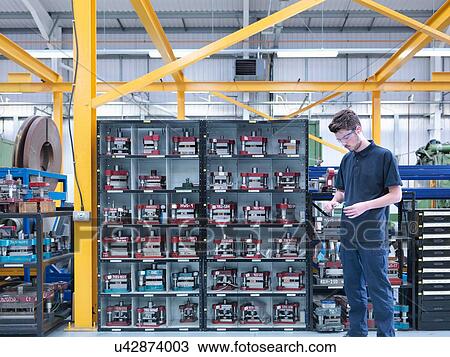 Apprentice engineer with engineering tools in engineering factory View Large Photo Image Stock Image - Apprentice engineer with engineering tools in engineering factory. Fotosearch