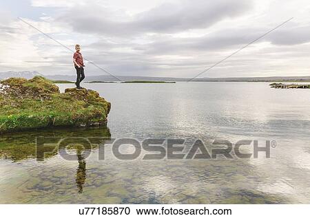 Boy looking down from lakeside, Thingvellir, Iceland View Large Photo Image Stock Image - Boy looking down from lakeside, Thingvellir, Iceland. Fotosearch