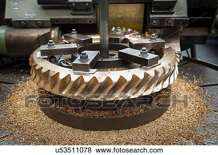 Stock Photo - Bronze worm gear wheel in lathe in engineering factory. Fotosearch