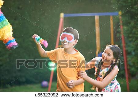 Children playing pinata in garden View Large Photo Image Stock Image - Children playing pinata in garden. Fotosearch