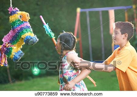 Children playing pinata in garden View Large Photo Image Stock Photo - Children playing pinata in garden. Fotosearch