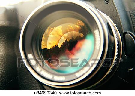 Close up sunset clouds reflected in camera lens View Large Photo Image Stock Image - Close up sunset clouds reflected in camera lens. Fotosearch