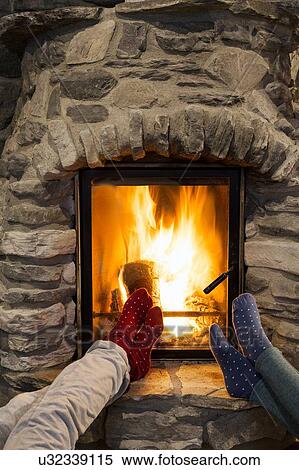 Cropped shot of two young women with feet up in front of fireplace View Large Photo Image Stock Photography - Cropped shot of two young women with feet up in front of fireplace. Fotosearch
