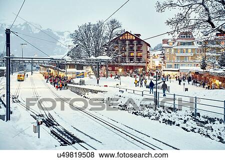 Crowds of passengers at snow covered train station, Wengen, Switzerland View Large Photo Image Stock Photo - Crowds of passengers at snow covered train station, Wengen, Switzerland. Fotosearch