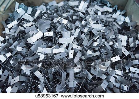 Stock Photo - Cut metal parts in engineering factory, close up. Fotosearch