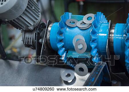 Cut metal washers on machine in engineering factory, close up View Large Photo Image Stock Image - Cut metal washers on machine in engineering factory, close up. Fotosearch