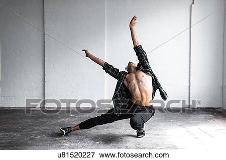 Stock Photo - Dancer practising in studio. Fotosearch
