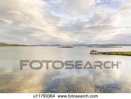 Distant view of hikers relaxing on lake pier, Thingvellir, Iceland View Large Photo Image Picture - Distant view of hikers relaxing on lake pier, Thingvellir, Iceland. Fotosearch