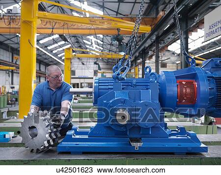 Engineer assembling industrial gearbox in engineering factory View Large Photo Image Stock Image - Engineer assembling industrial gearbox in engineering factory. Fotosearch