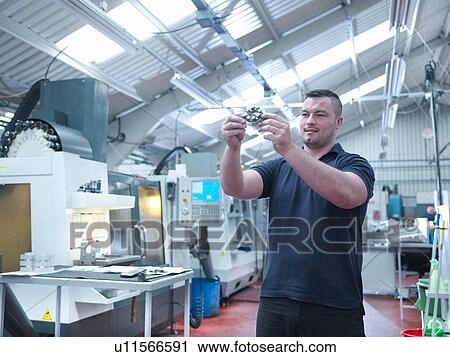 Engineer inspecting machined part in engineering factory View Large Photo Image Stock Image - Engineer inspecting machined part in engineering factory. Fotosearch