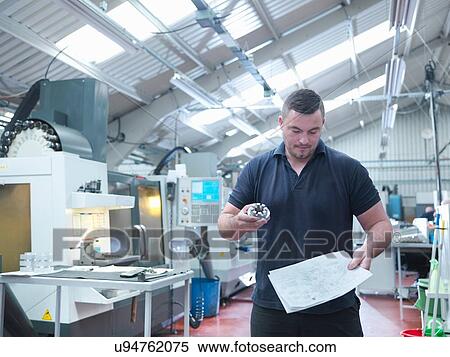 Engineer inspecting machined part in engineering factory View Large Photo Image Stock Photography - Engineer inspecting machined part in engineering factory. Fotosearch