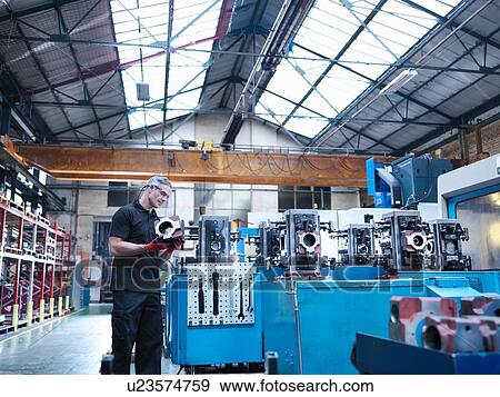 Engineer inspecting parts on automatic lathe in engineering factory View Large Photo Image Stock Photo - Engineer inspecting parts on automatic lathe in engineering factory. Fotosearch