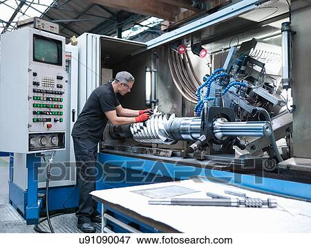 Engineer inspecting worm drive gear in lathe in engineering factory View Large Photo Image Stock Photo - Engineer inspecting worm drive gear in lathe in engineering factory. Fotosearch
