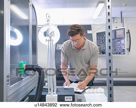 Engineer making notes in orthopaedic factory View Large Photo Image Stock Image - Engineer making notes in orthopaedic factory. Fotosearch