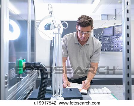 Engineer making notes in orthopaedic factory View Large Photo Image Stock Image - Engineer making notes in orthopaedic factory. Fotosearch