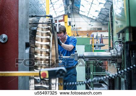 Engineer measuring gear wheel in lathe in engineering factory View Large Photo Image Stock Photography - Engineer measuring gear wheel in lathe in engineering factory. Fotosearch