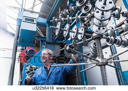 Engineer with shot blasted gear wheels in engineering factory View Large Photo Image Stock Photo - Engineer with shot blasted gear wheels in engineering factory. Fotosearch