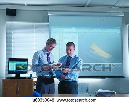 Engineering designers with CAD images on screen in engineering factory View Large Photo Image Stock Photo - Engineering designers with CAD images on screen in engineering factory. Fotosearch