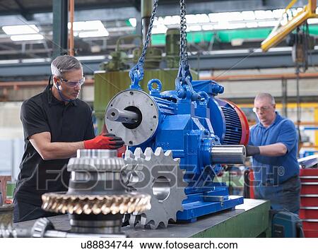 Engineers assembling industrial gearbox in engineering factory View Large Photo Image Picture - Engineers assembling industrial gearbox in engineering factory. Fotosearch