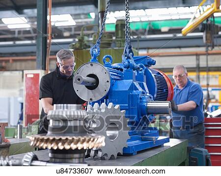 Engineers assembling industrial gearbox in engineering factory View Large Photo Image Stock Photo - Engineers assembling industrial gearbox in engineering factory. Fotosearch