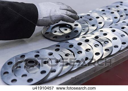 Engineers hand arranging cut parts in engineering factory, close up View Large Photo Image Stock Photo - Engineers hand arranging cut parts in engineering factory, close up. Fotosearch