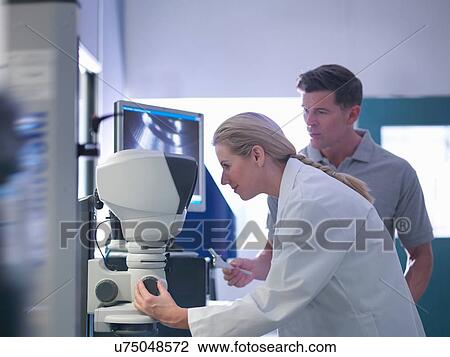 Engineers inspecting artificial hip joint parts using electron microscope in orthopaedic factory View Large Photo Image Stock Image - Engineers inspecting artificial hip joint parts using electron microscope in orthopaedic factory. Fotosearch