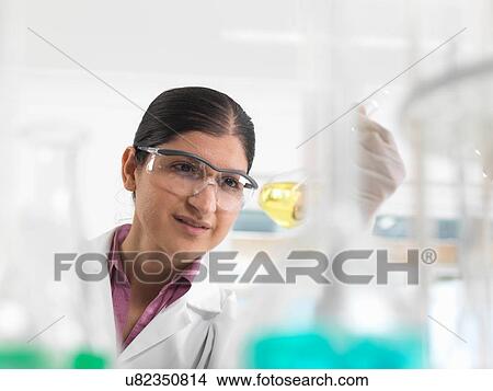Picture - Female chemical scientist developing formula in laboratory. Fotosearch