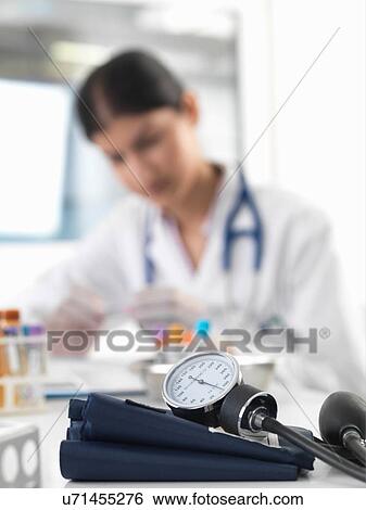 Female doctor examining test tube at desk in clinic View Large Photo Image Stock Photograph - Female doctor examining test tube at desk in clinic. Fotosearch