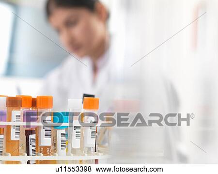Female doctor preparing blood and urine samples at desk View Large Photo Image Stock Photo - Female doctor preparing blood and urine samples at desk. Fotosearch