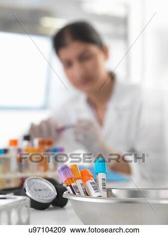 Female doctor preparing blood samples at desk View Large Photo Image Stock Photo - Female doctor preparing blood samples at desk. Fotosearch