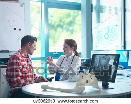 Female orthopaedic consultant with patient in consulting room View Large Photo Image Stock Image - Female orthopaedic consultant with patient in consulting room. Fotosearch