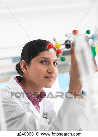 Female scientist in laboratory, viewing molecular model of a chemical formula View Large Photo Image Stock Image - Female scientist in laboratory, viewing molecular model of a chemical formula. Fotosearch