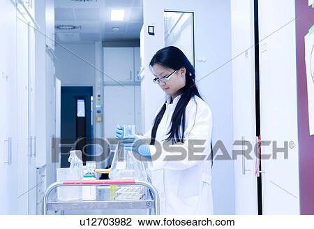 Female scientist preparing experiment equipment for trolley in laboratory View Large Photo Image Stock Image - Female scientist preparing experiment equipment for trolley in laboratory. Fotosearch