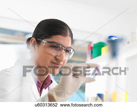 Female scientist viewing sample in eppendorf ahead of DNA testing in a laboratory. View Large Photo Image Stock Image - Female scientist viewing sample in eppendorf ahead of DNA testing in a laboratory.. Fotosearch