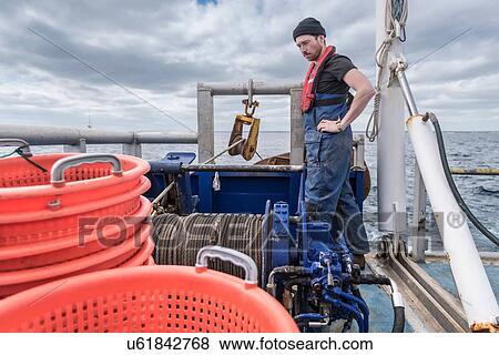 Fisherman with winch on trawler research ship View Large Photo Image Stock Photo - Fisherman with winch on trawler research ship. Fotosearch