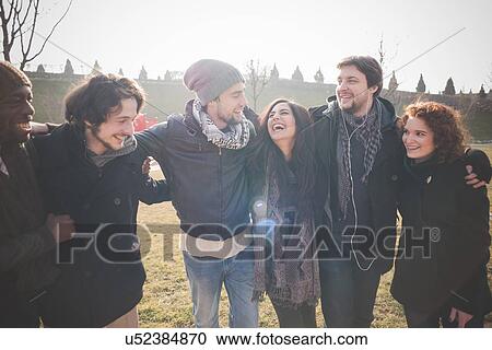 Stock Image - Five young adult friends in park. Fotosearch