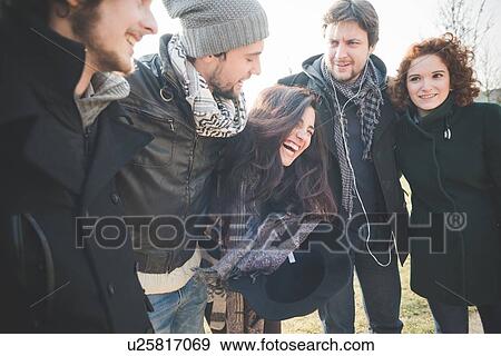 Stock Photo - Five young adult friends laughing together in park. Fotosearch