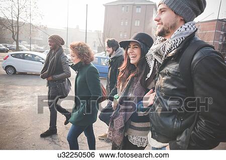 Five young adult friends strolling in city View Large Photo Image Stock Photograph - Five young adult friends strolling in city. Fotosearch