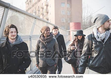 Five young adult friends strolling on footbridge View Large Photo Image Stock Photography - Five young adult friends strolling on footbridge. Fotosearch