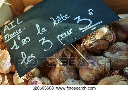 Stock Photo - Fresh garlic on French market stall, close-up. Fotosearch