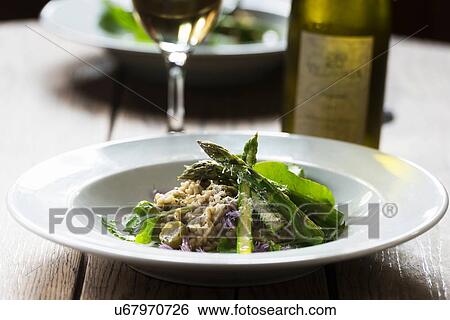 Stock Photograph - Freshly prepared meal with asparagus and chives, close-up. Fotosearch