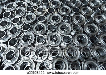 Stock Image - Gear wheels in production in engineering factory. Fotosearch