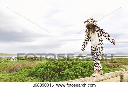 Girl wearing animal onesie balancing on wooden fence, Thingvellir, Iceland View Large Photo Image Stock Photography - Girl wearing animal onesie balancing on wooden fence, Thingvellir, Iceland. Fotosearch