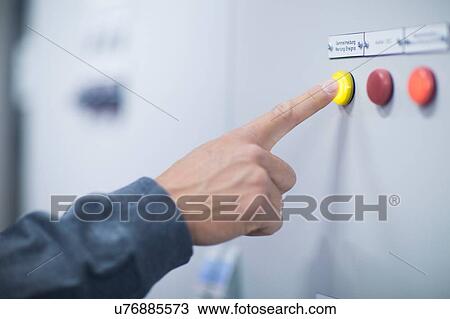 Hand of male technician pressing yellow button on control panel View Large Photo Image Stock Image - Hand of male technician pressing yellow button on control panel. Fotosearch